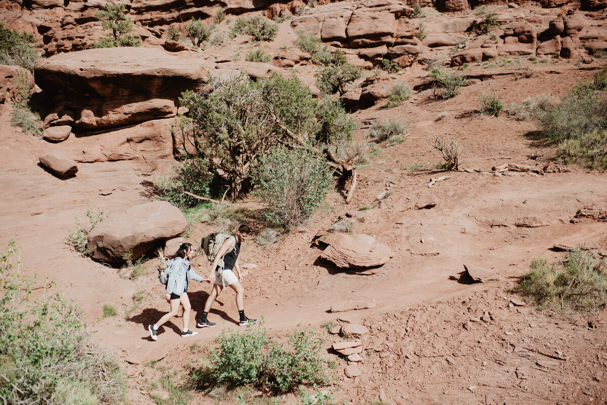 Utah Elopement Photographer captures couple walking through Moab together before Moab elopement