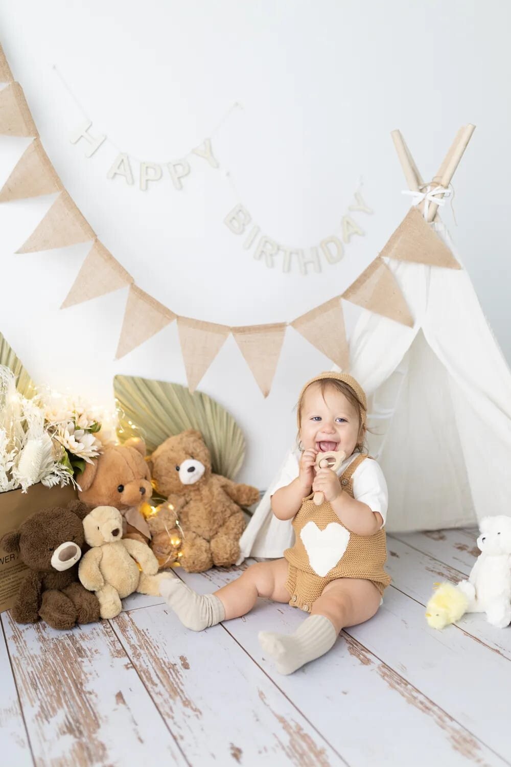 Baby boy in birthday setup with teddy bears and banner - first birthday milestone in Maple Grove studio