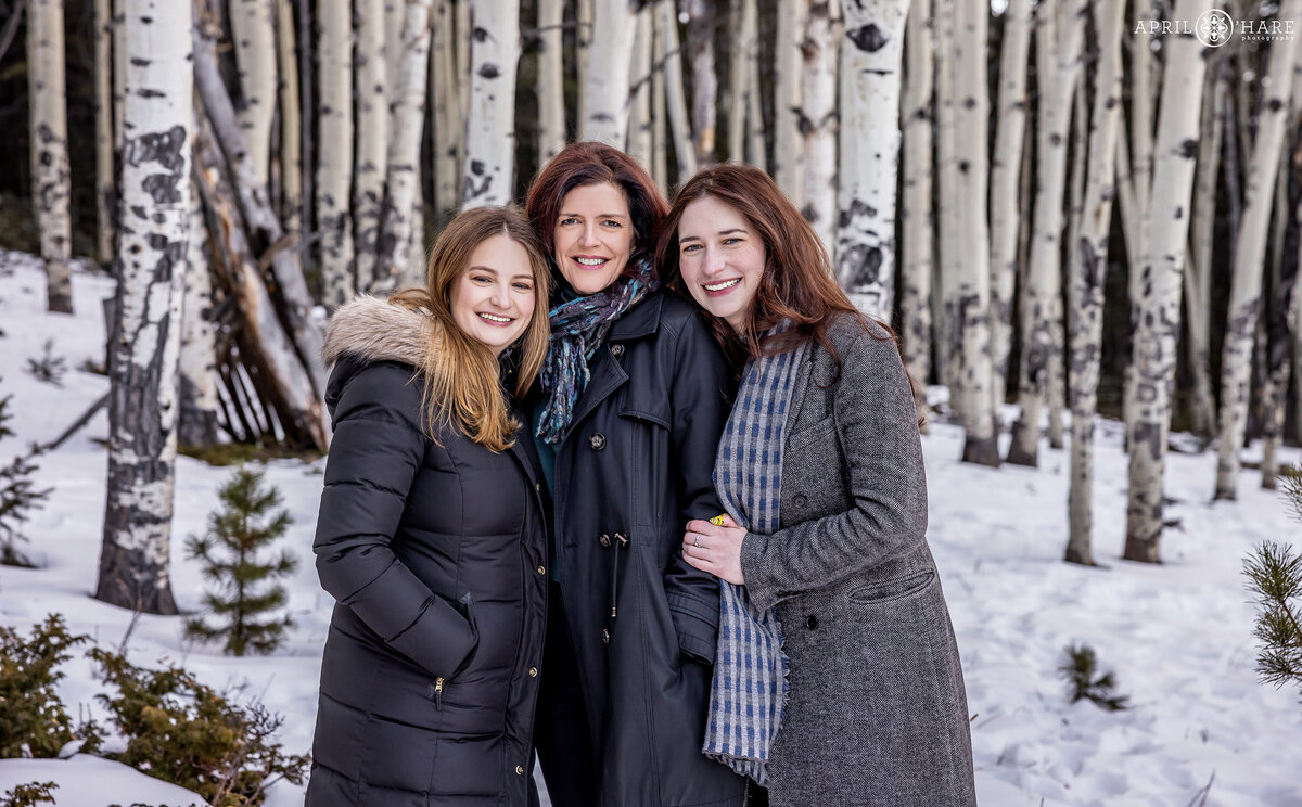 Pretty Snowy Winter Family Photo of Mom with her Two Adult Daughters in Evergreen Colorado