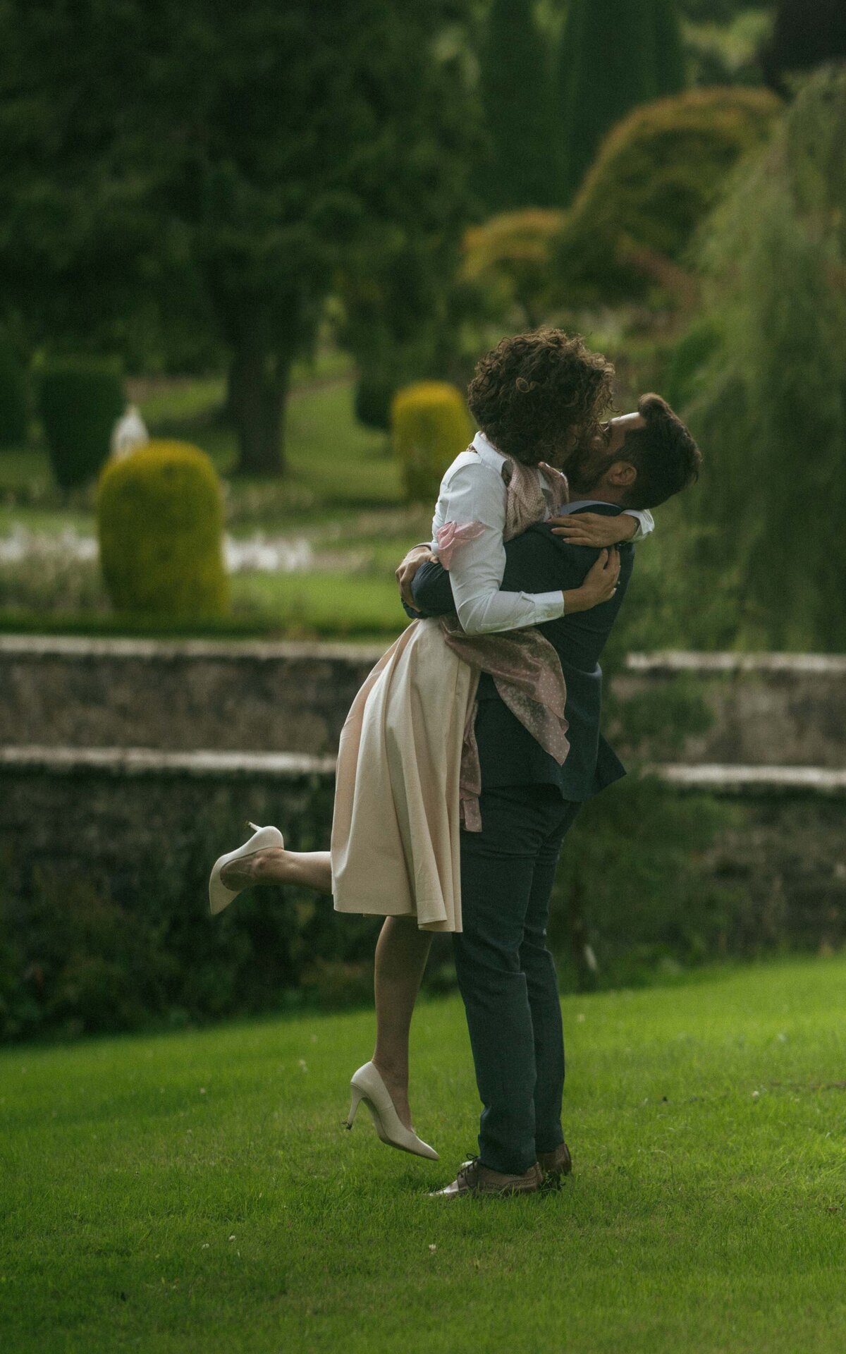 A romantic couple photoshoot in a lush garden, capturing intimate moments surrounded by vibrant flowers and natural beauty
