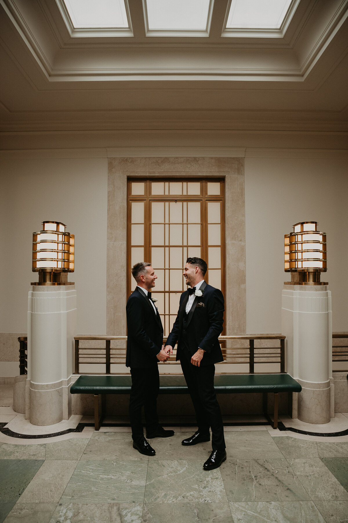 Two grooms upstairs at Hackney Town Hall. 