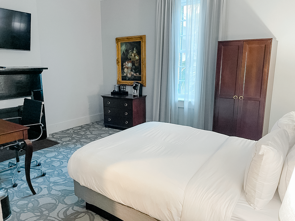 Boutique hotel guest room with armoire