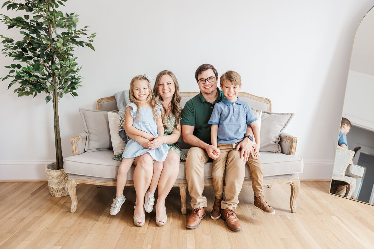 a family posing together on a sofa