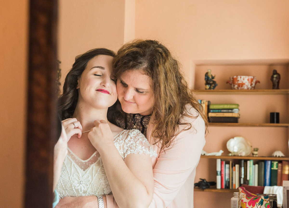 mother of the bride embracing her daughter during wedding preparations in Westcove House