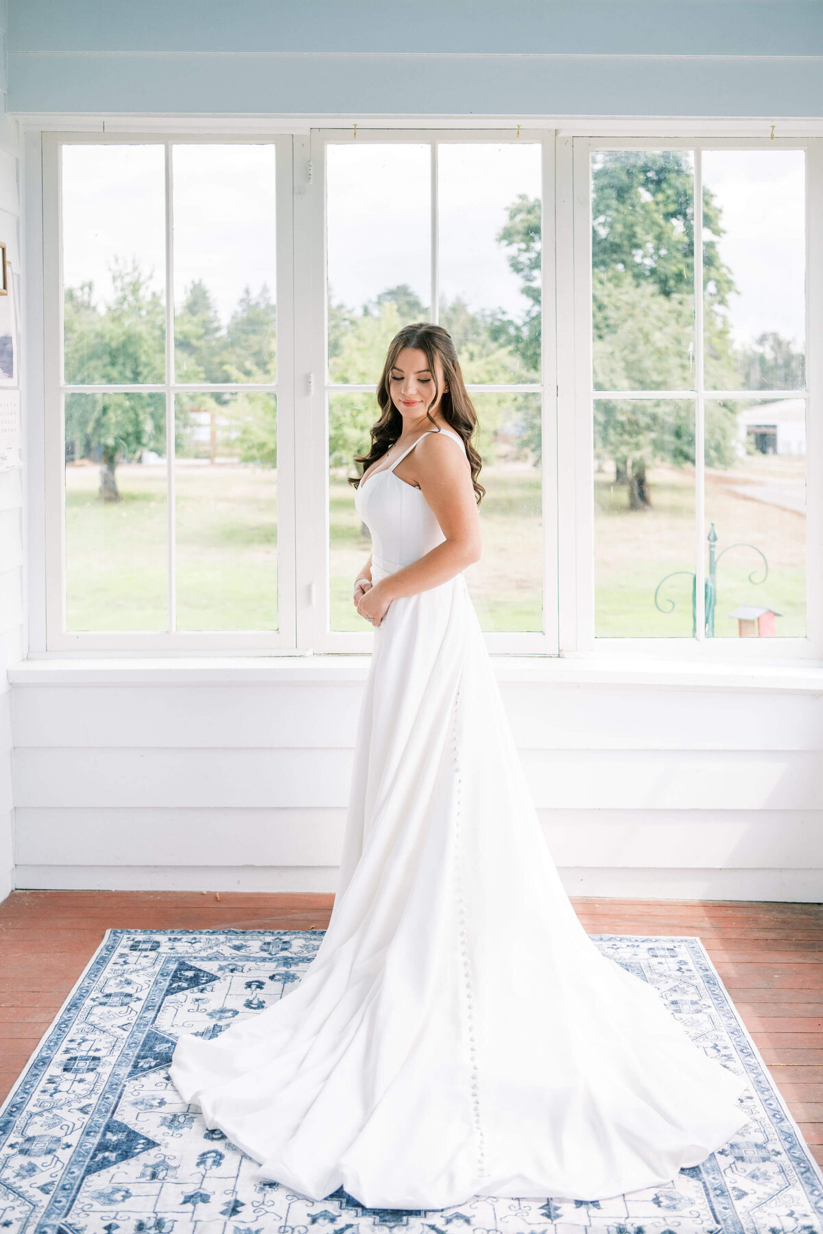 A bride poses in her wedding dress at a wedding planned by Birdie June Events.