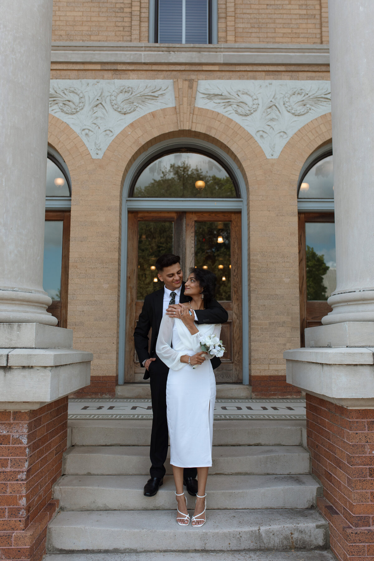 As a wedding photographer capturing an elopement at the courthouse in Houston, I witnessed the raw beauty of love in its simplest form. With the courthouse as their sanctuary, the couple exchanged vows in a ceremony filled with emotion and authenticity, creating a moment of profound intimacy and connection amidst the hustle and bustle of the city.