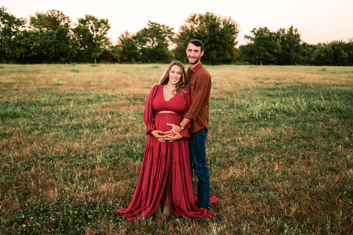 maternity photo in Springfield MO of couple cuddling holding baby bump