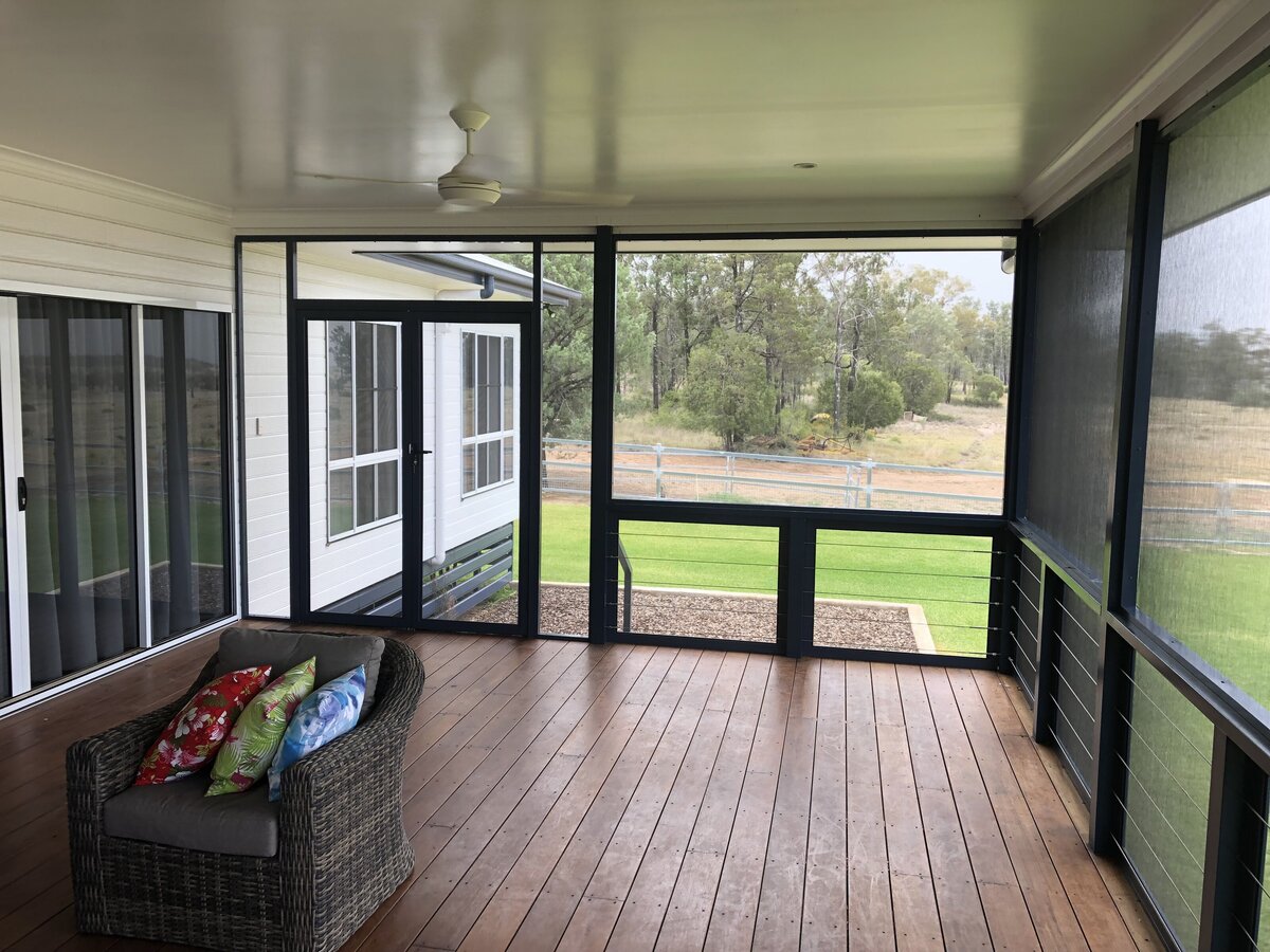 Enclosed patio featuring fly screens for insect protection and ventilation.
