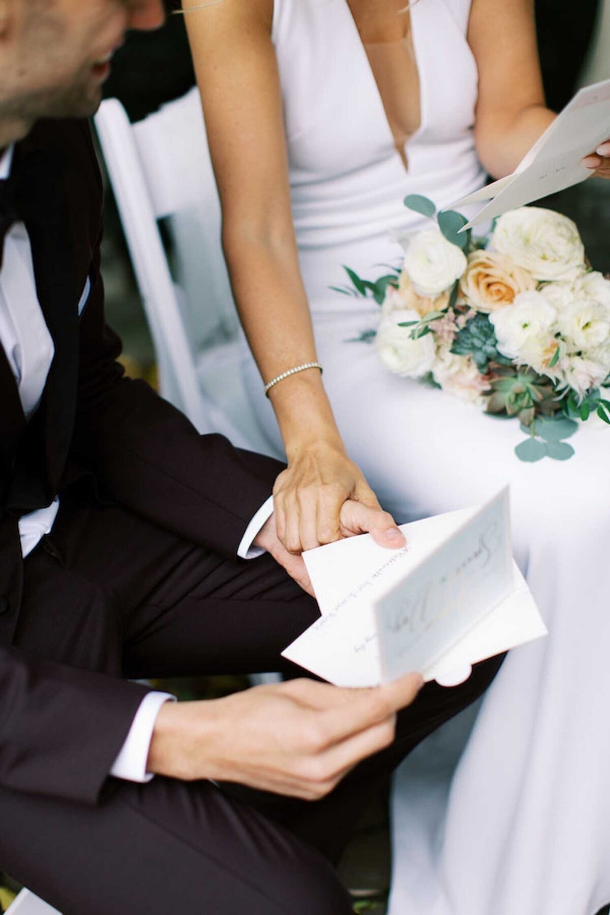 Bride and Groom exchange letters at their first look during a luxury Chicago outdoor garden wedding.
