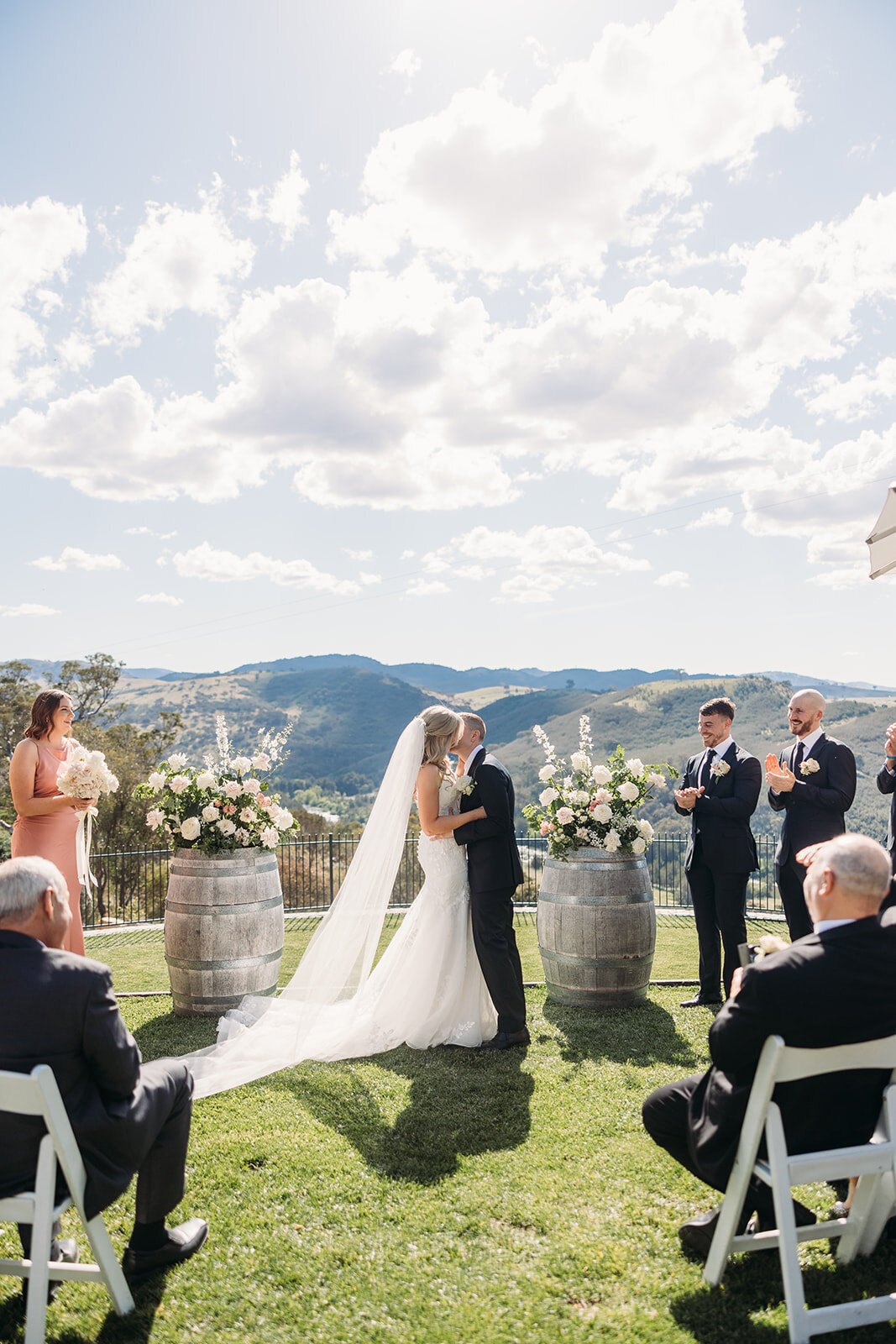 Bride and Groom's first kiss during their wedding ceremony at Brindabella Hills Winery