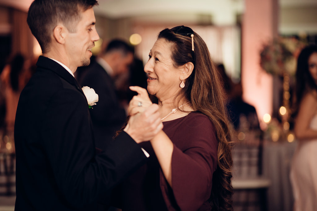 Wedding Photograph Of Groom Dancing With a Woman In Maroon Dress Los Angeles