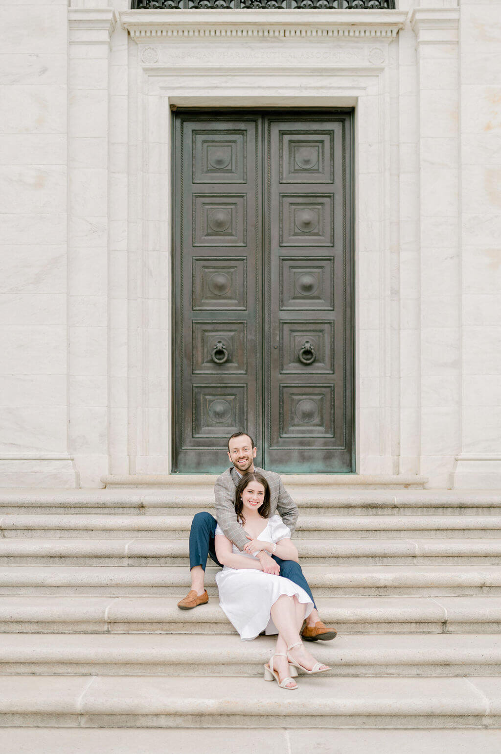 Couple sitting on stairs for engagement photos