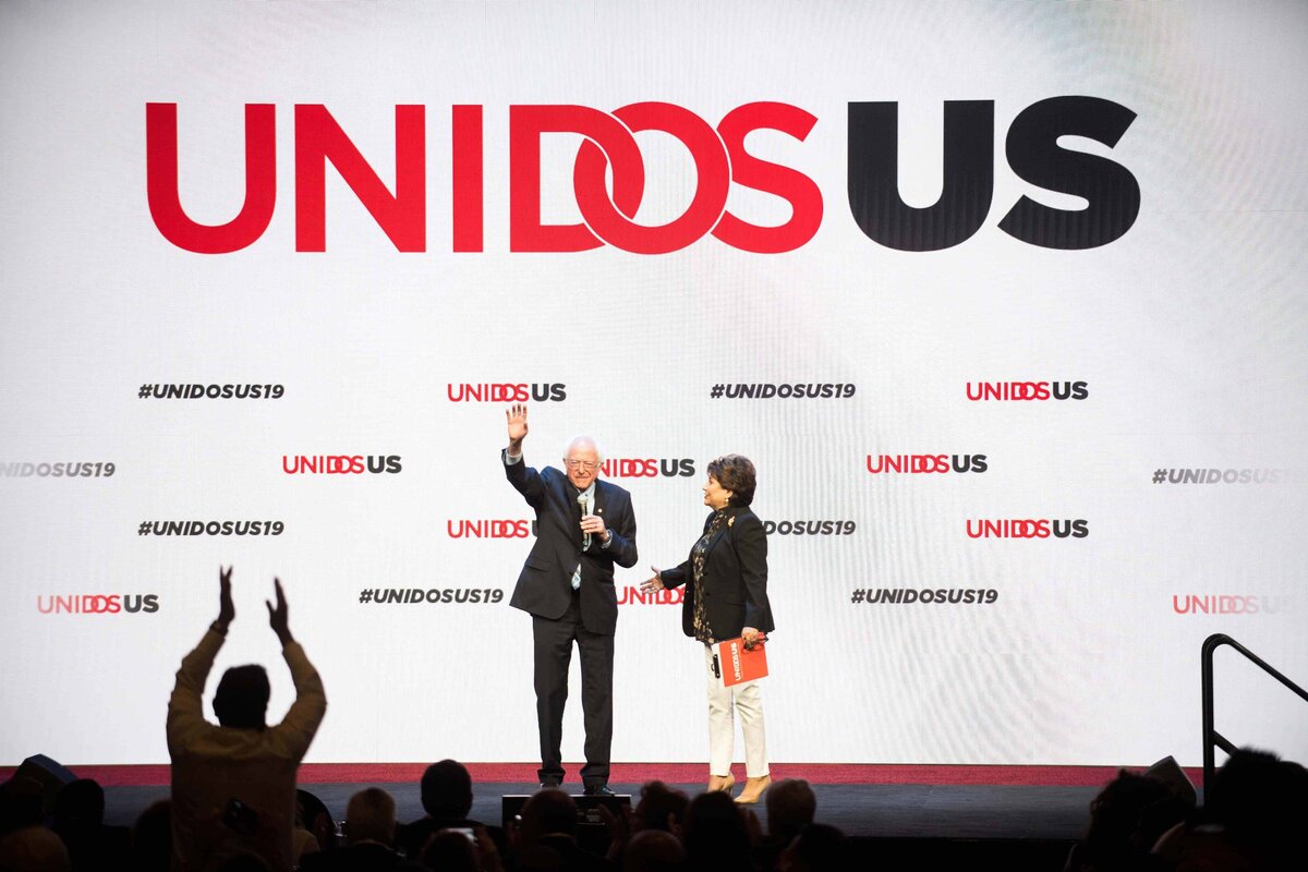 Presidential hopeful Bernie Sanders Speaks and a man stands to clap at UNIDOS US in San Diego