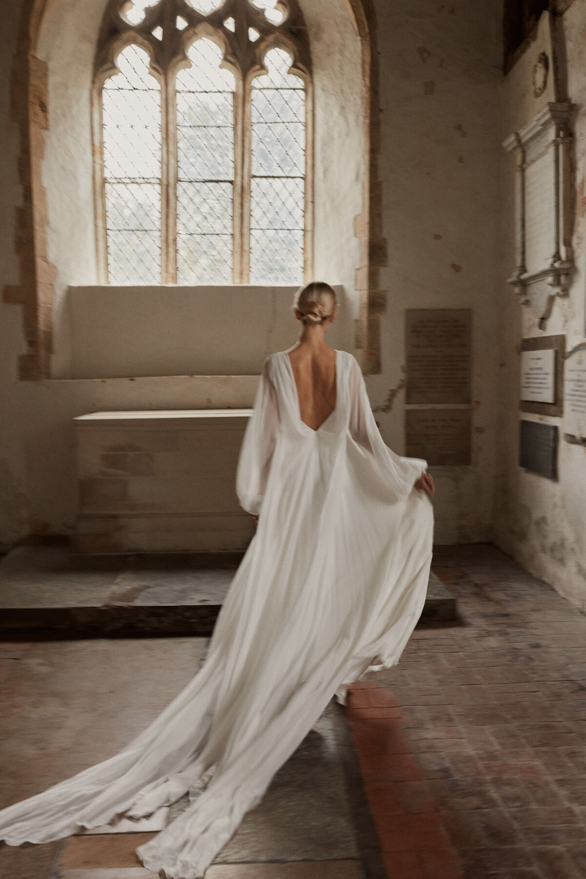 Flowing silk wedding dress with deep v back design by Luna Bea, British Bridal Designer