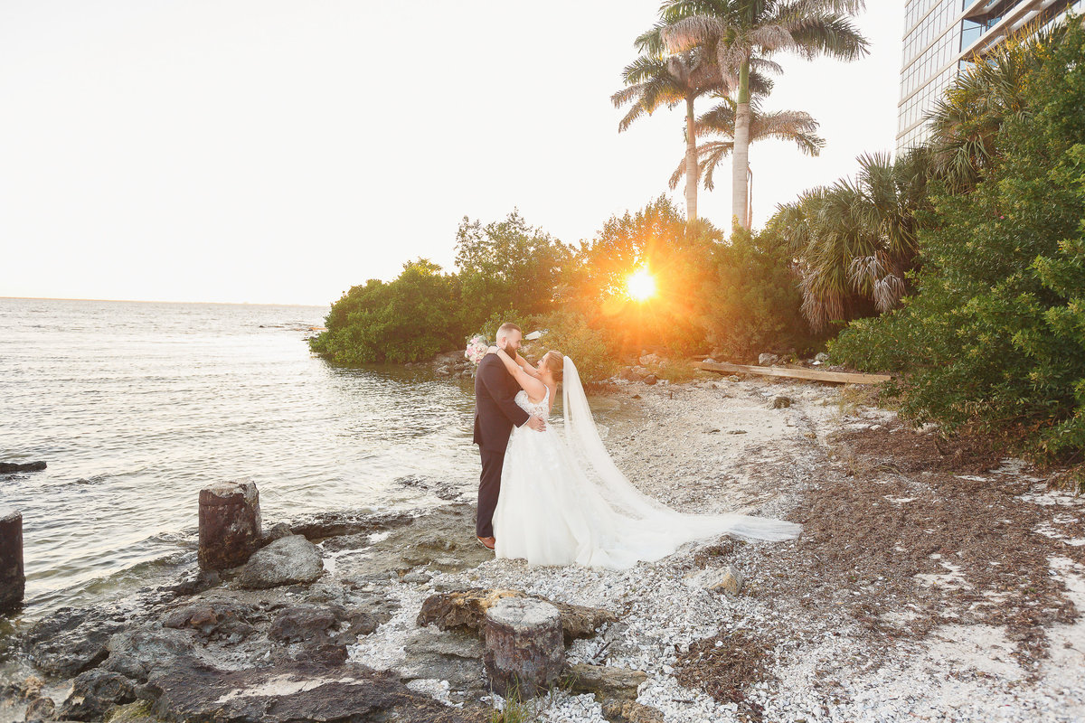 Bride and Groom on the Shore at Sunset at their Tampa Bay Wedding