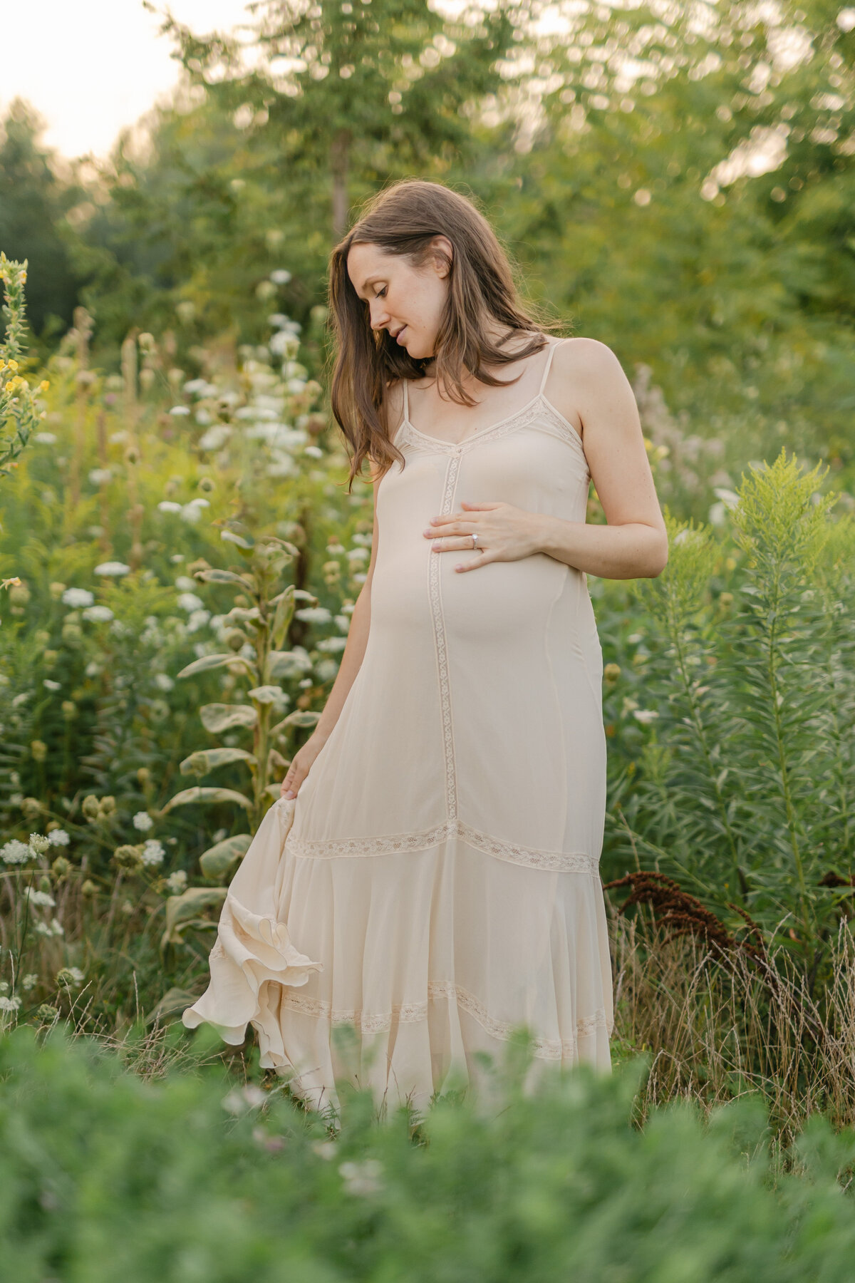 pregnant woman in beige dress in a field