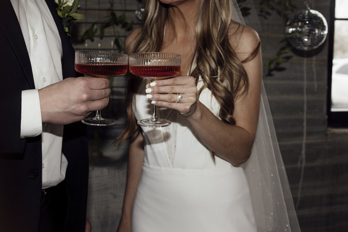 bride-and-groom-cheers-with-glasses
