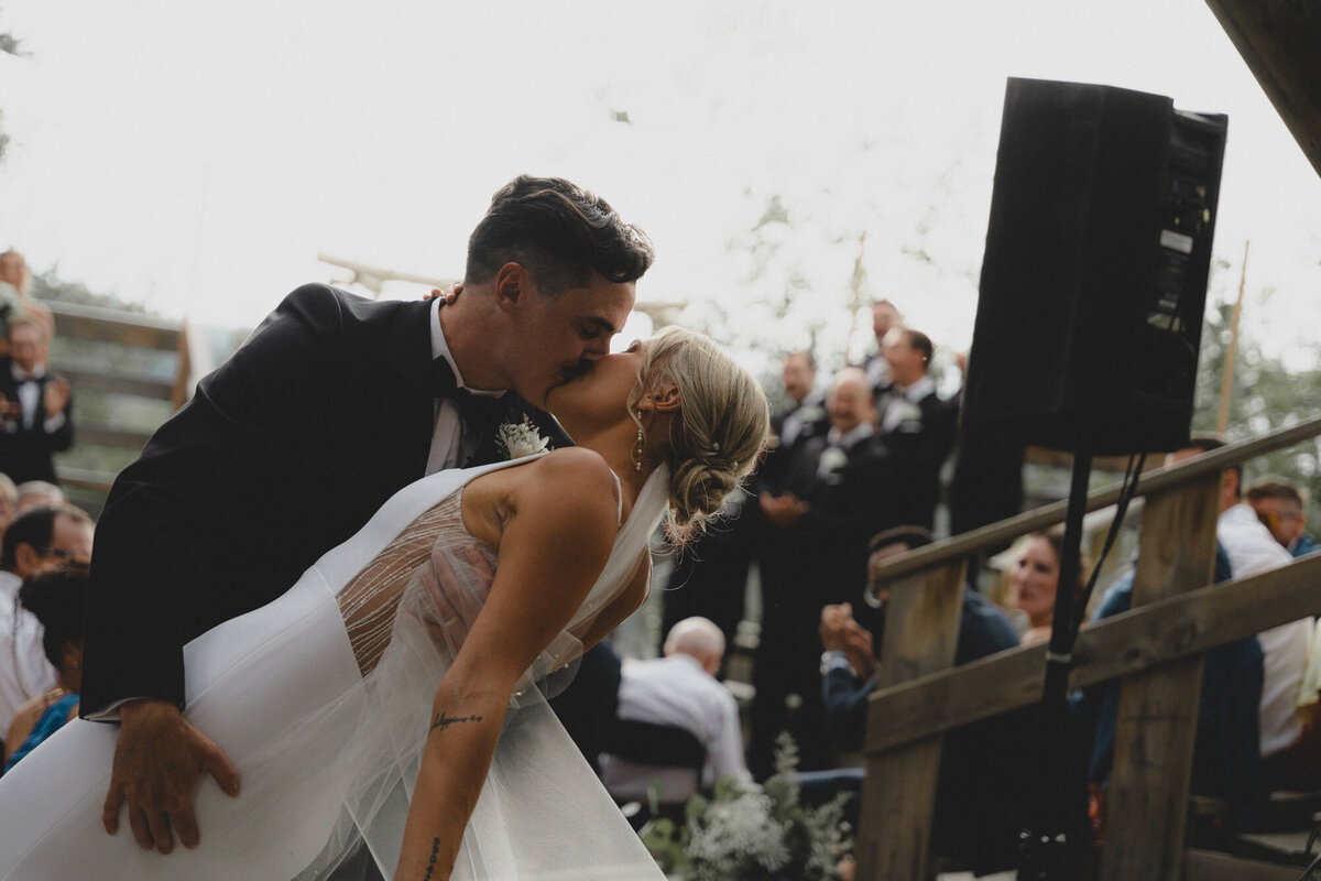 Wedding couple doing a dip kiss at Camp Horizon near Calgary, Alberta