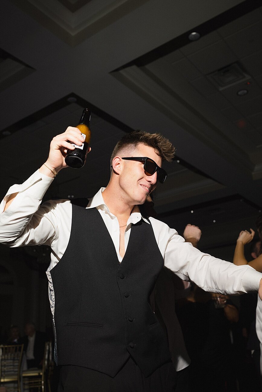 guy dancing with beer in hand at wedding recpetion