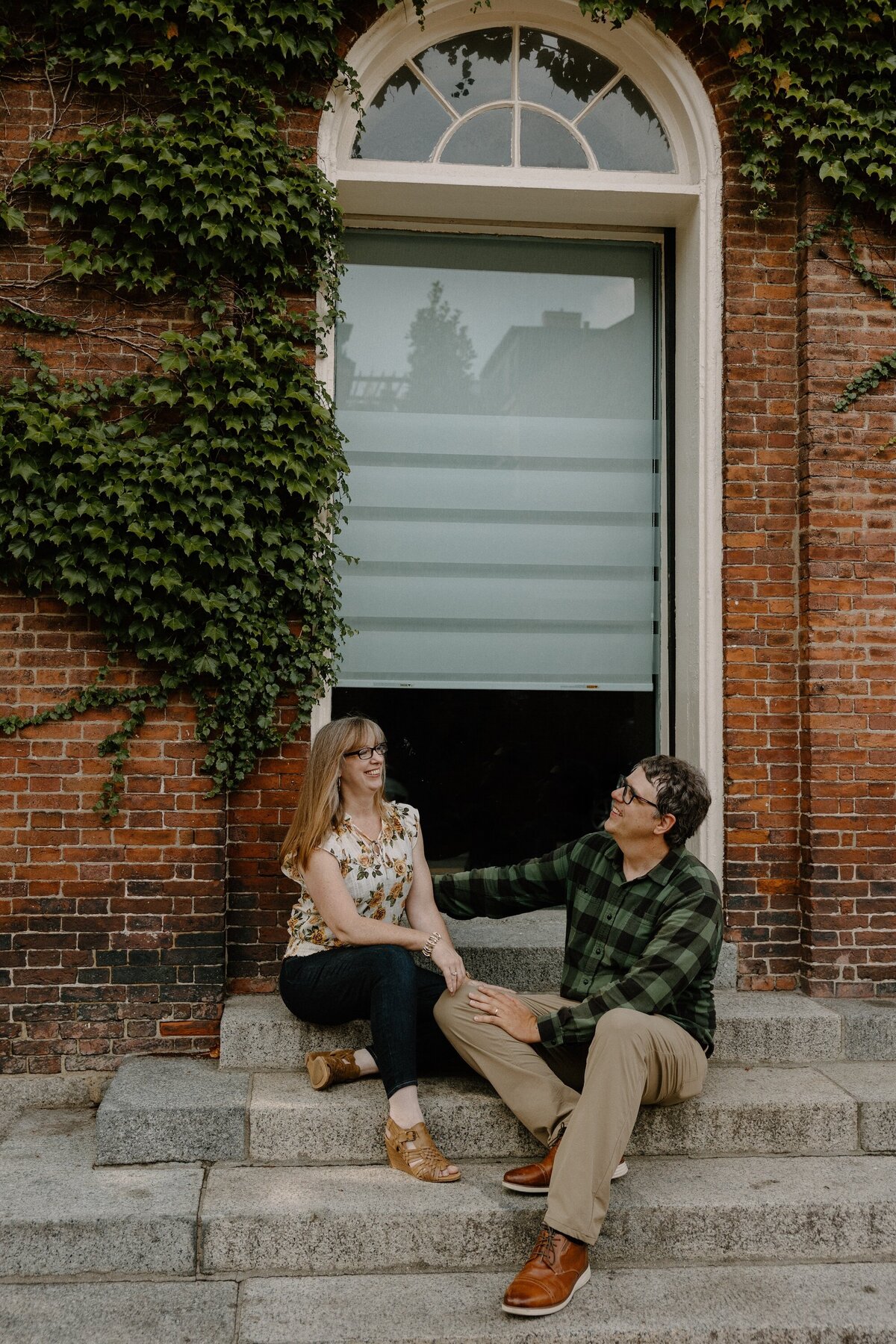 couple sitting on steps in downtown boston