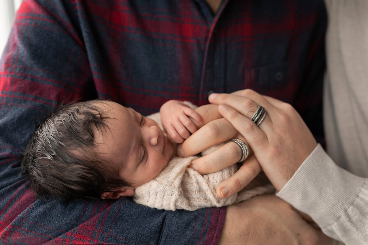 NJ baby photographer captures baby holding his dads' hands