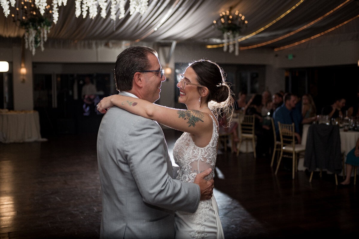 Groom adjusting cufflinks in mirror