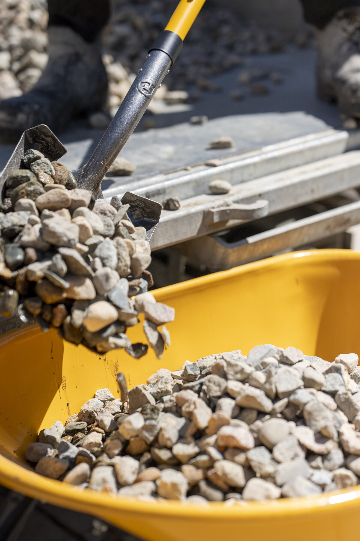 dumping rocks into a landscaping garden bed
