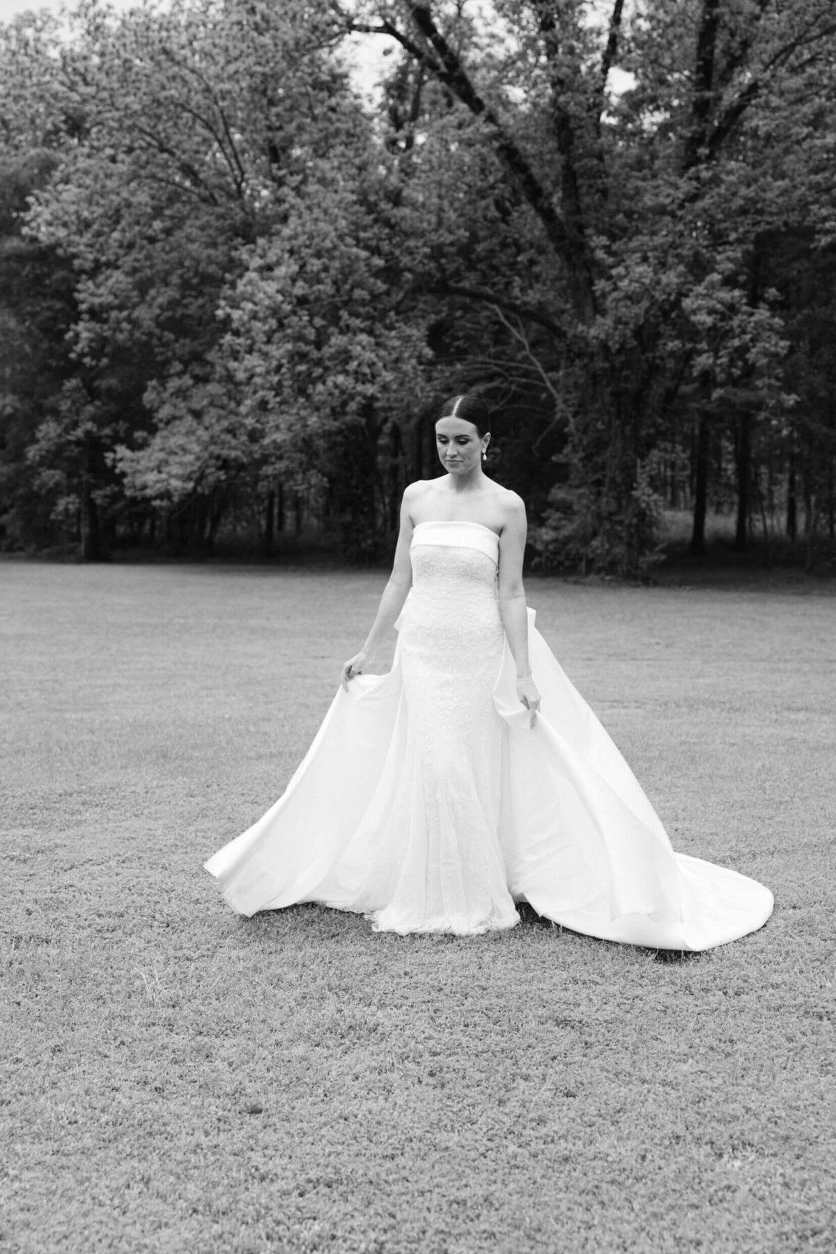 A black and white wedding day photo of the bride in her white dress