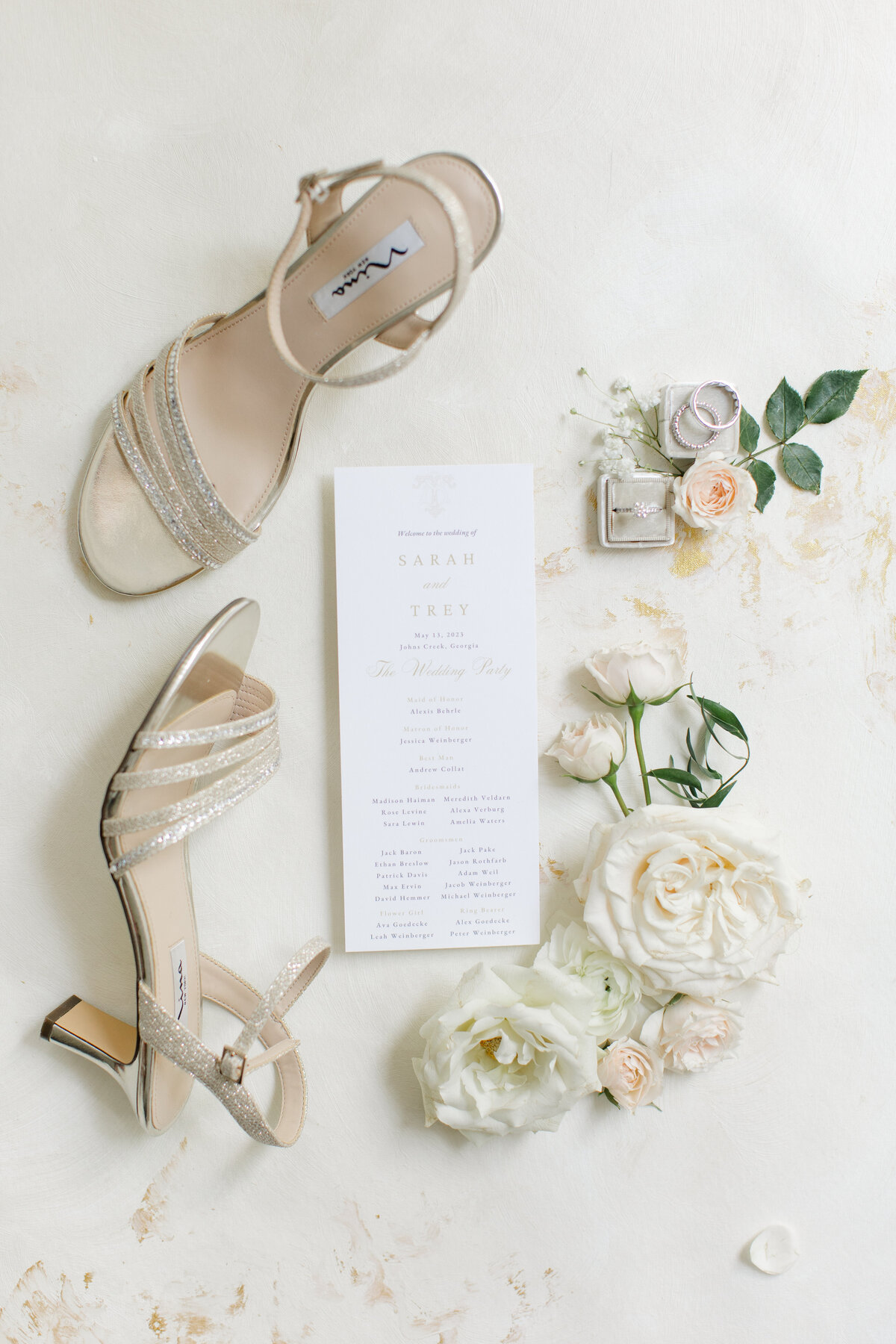 Gold wedding heels with a white calligraphy wedding program