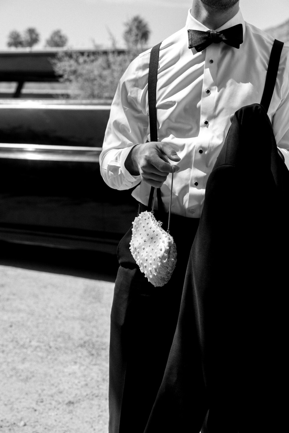 Groom holding bride's purse
