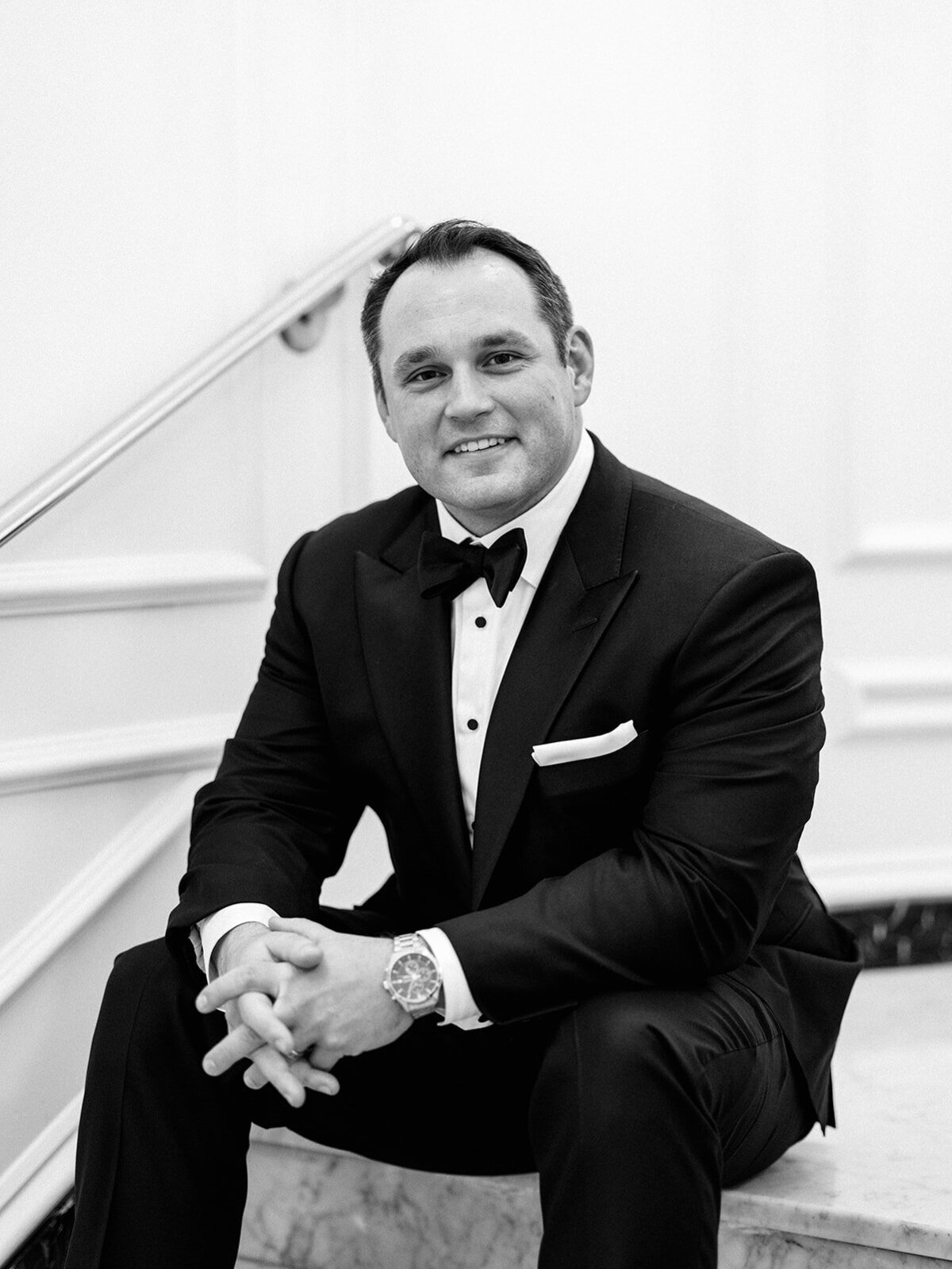 Groom sitting on the steps