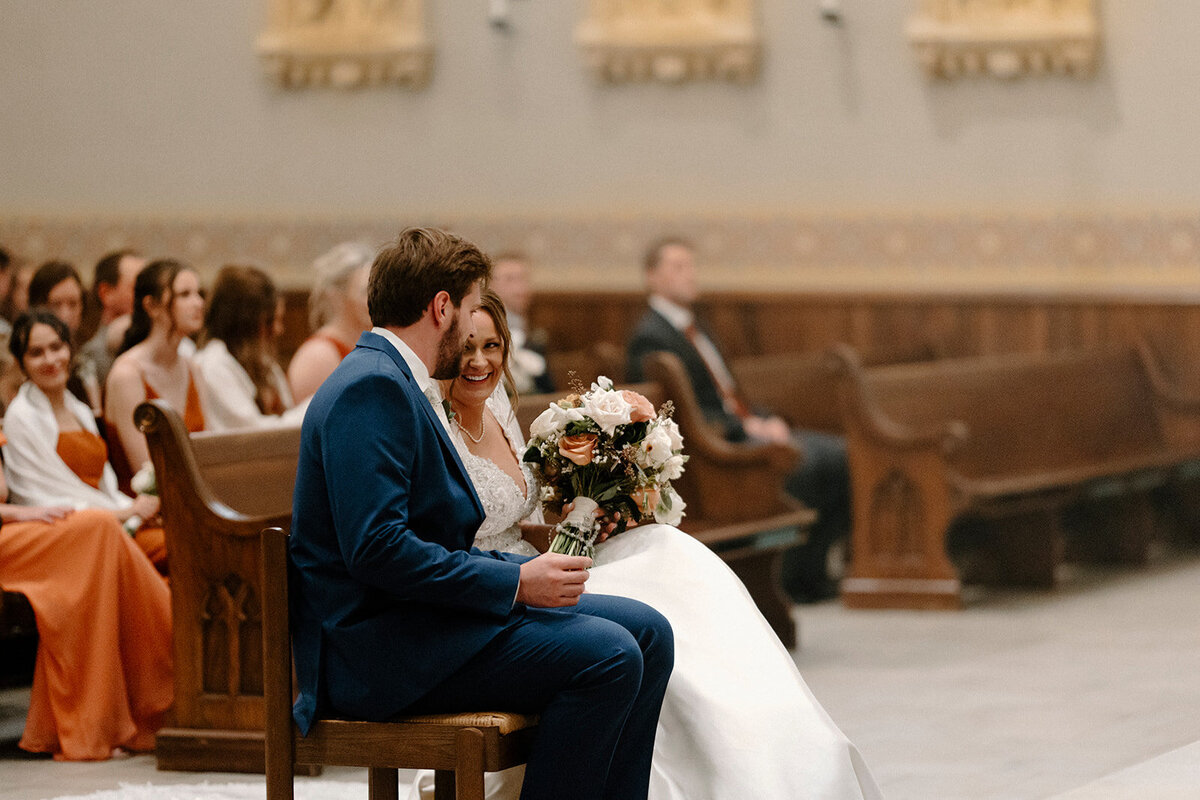 bride and groom smiling during Catholic Mass