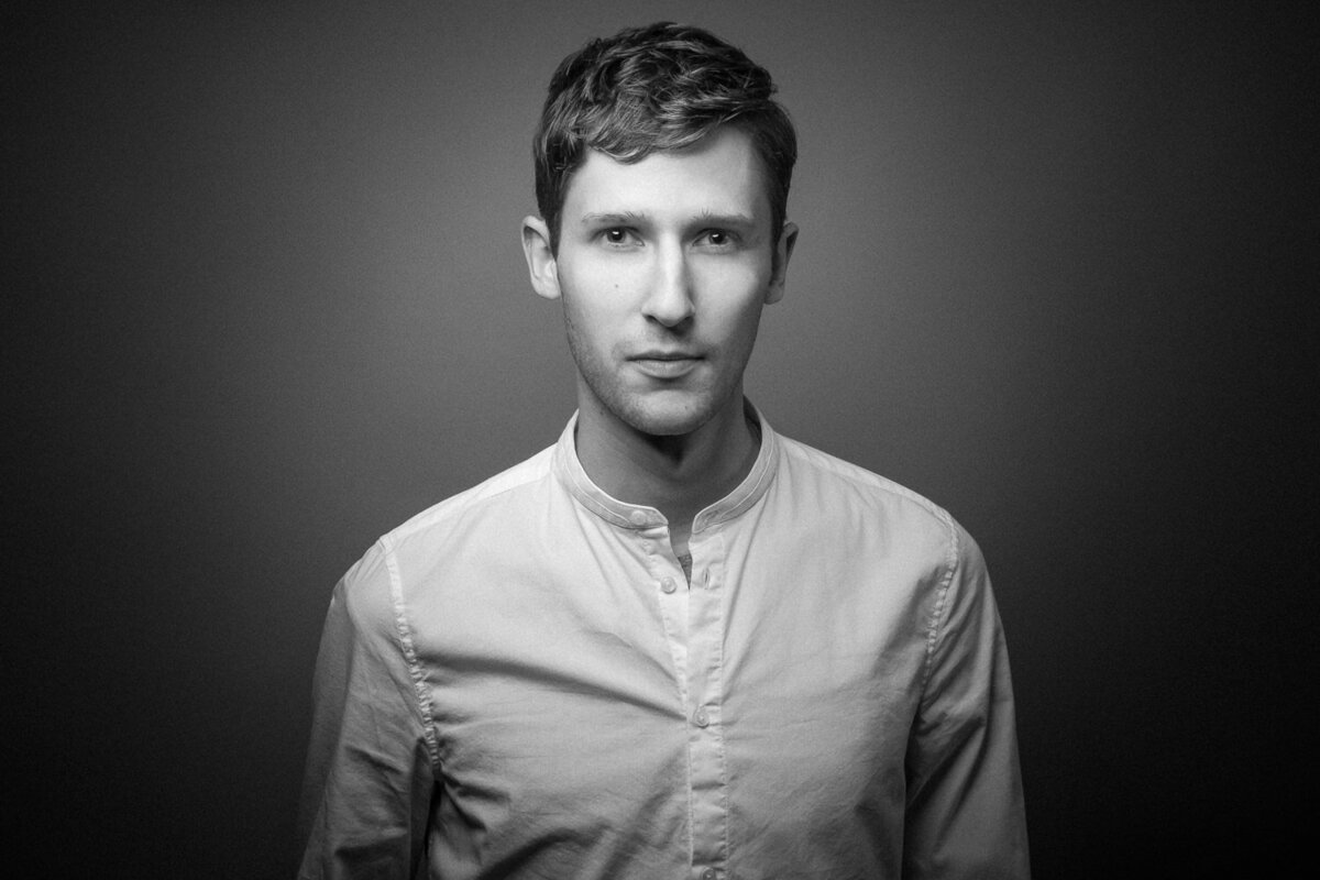 Striking studio portrait of a man photographed in a bold, editorial style.