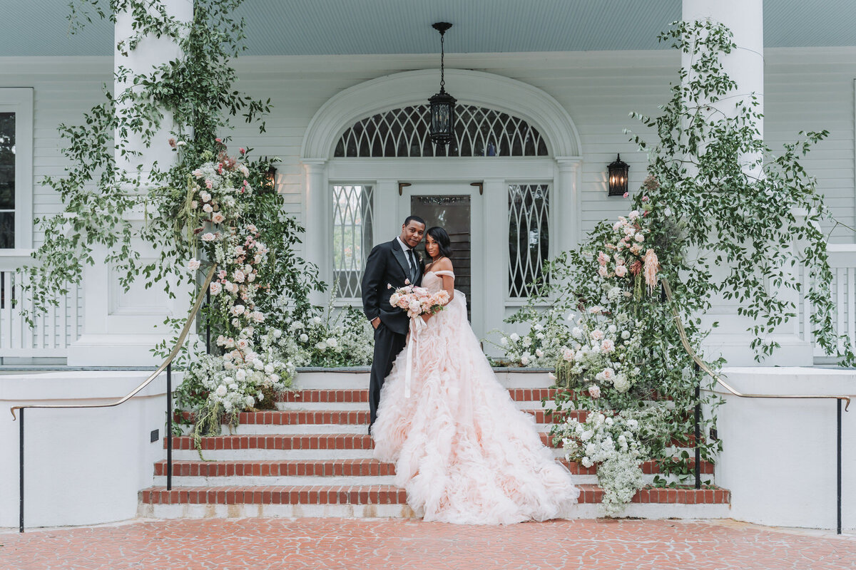 bride and groom smile at camera at wedding ceremony