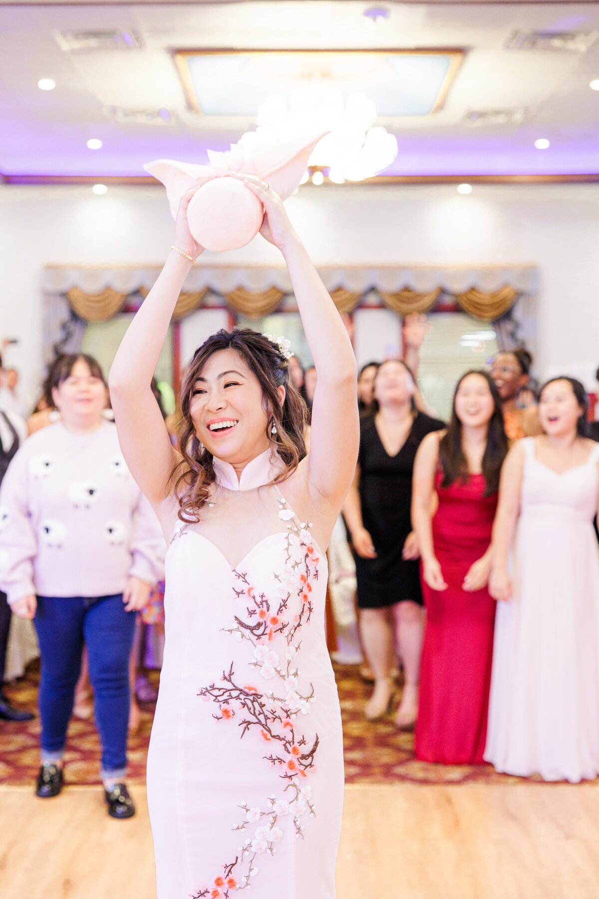 Bride doing a bouquet toss during her Boston wedding