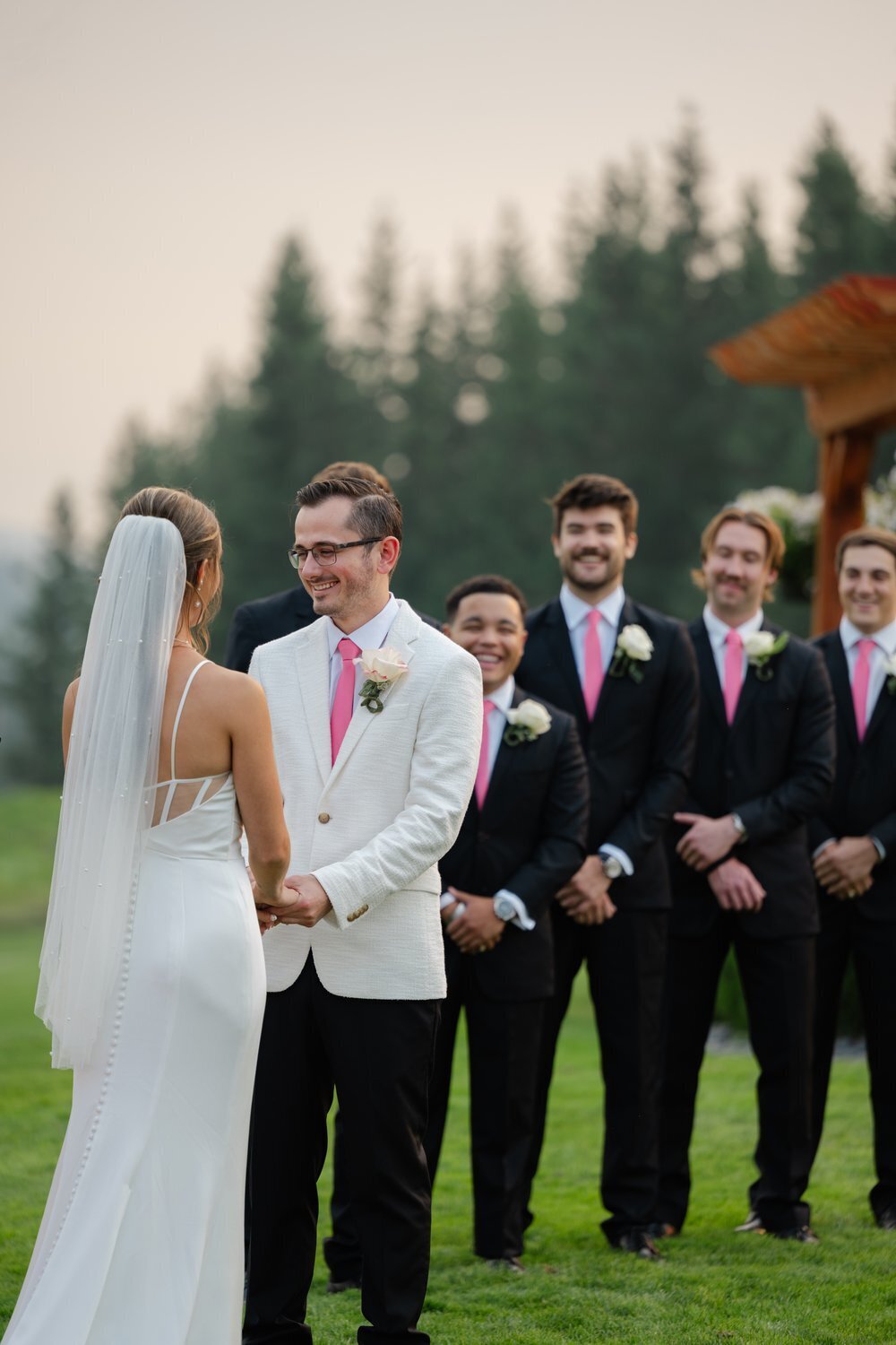 bride and groom at altar with groomsmen behind groom