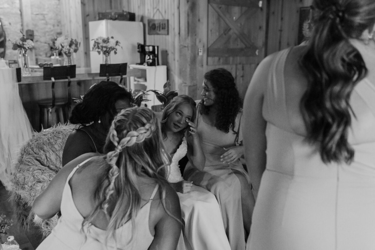 Wedding guests dancing in black and white, candid wedding reception photo.