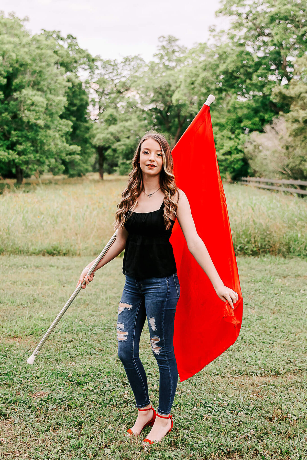 Senior with color guard flag