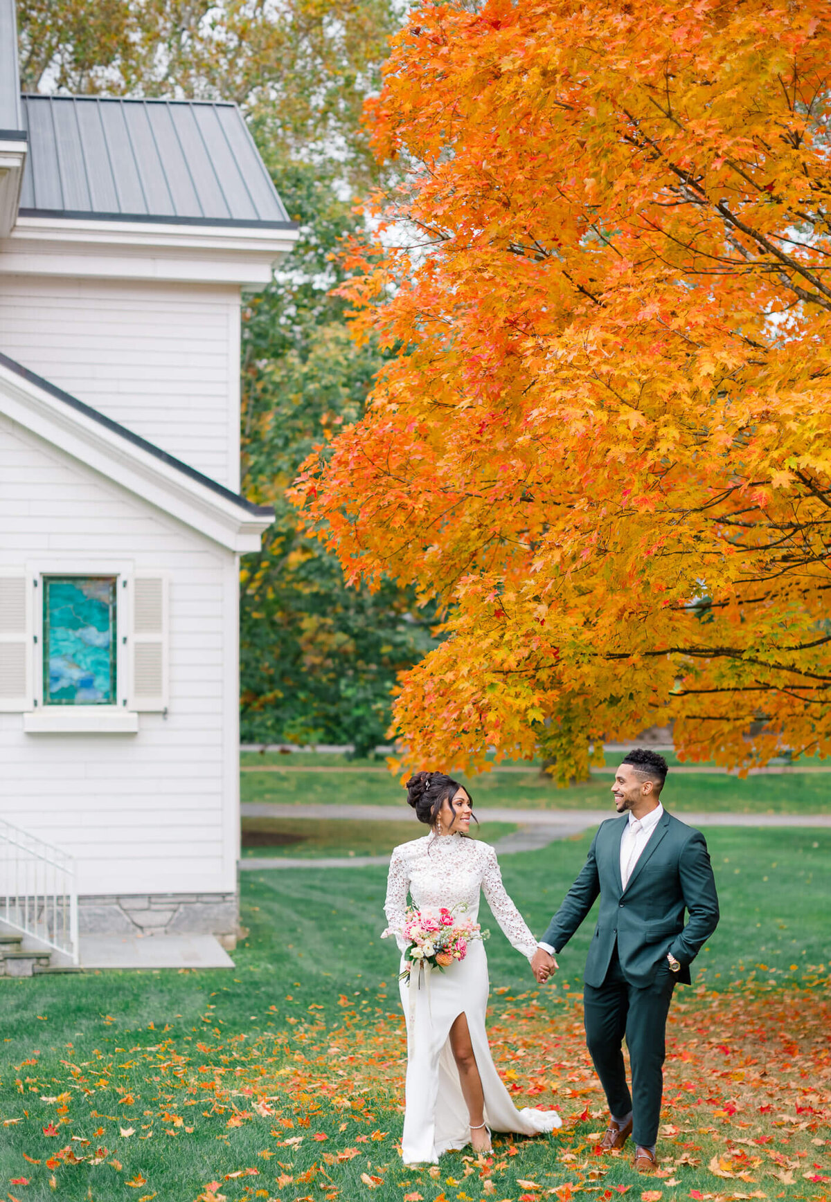 Bride and Groom walking by the chapel at The Greenbrier in White Sulfur Springs, West Virginia. Captured by Charlottesville Wedding Photogapher Bethany Aubre Photography.