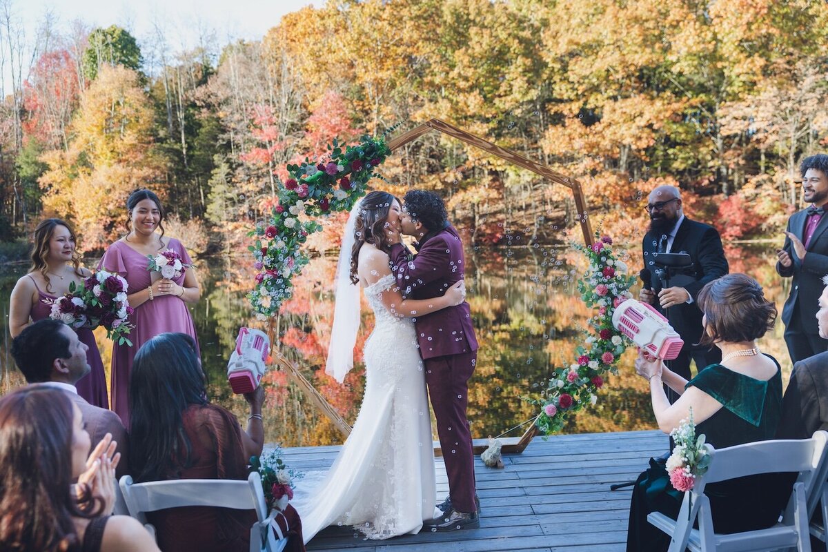 Bride and groom exchanging vows beside the water