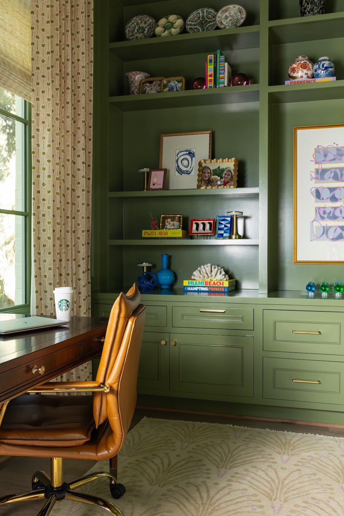 french lab designs green painted built-ins with styled shelves and leather office chair with desk