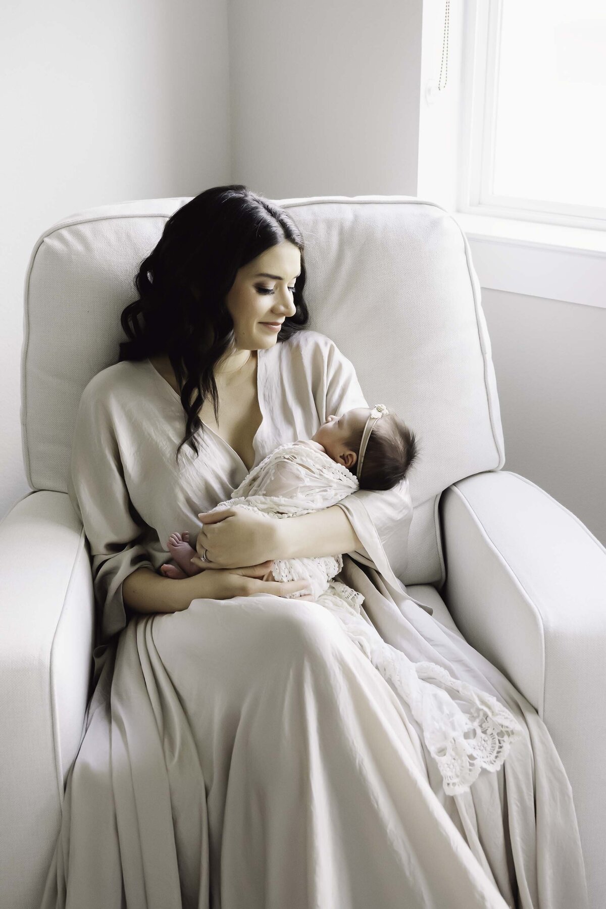 Mom and Baby Girl in Nursery Riocking Chair