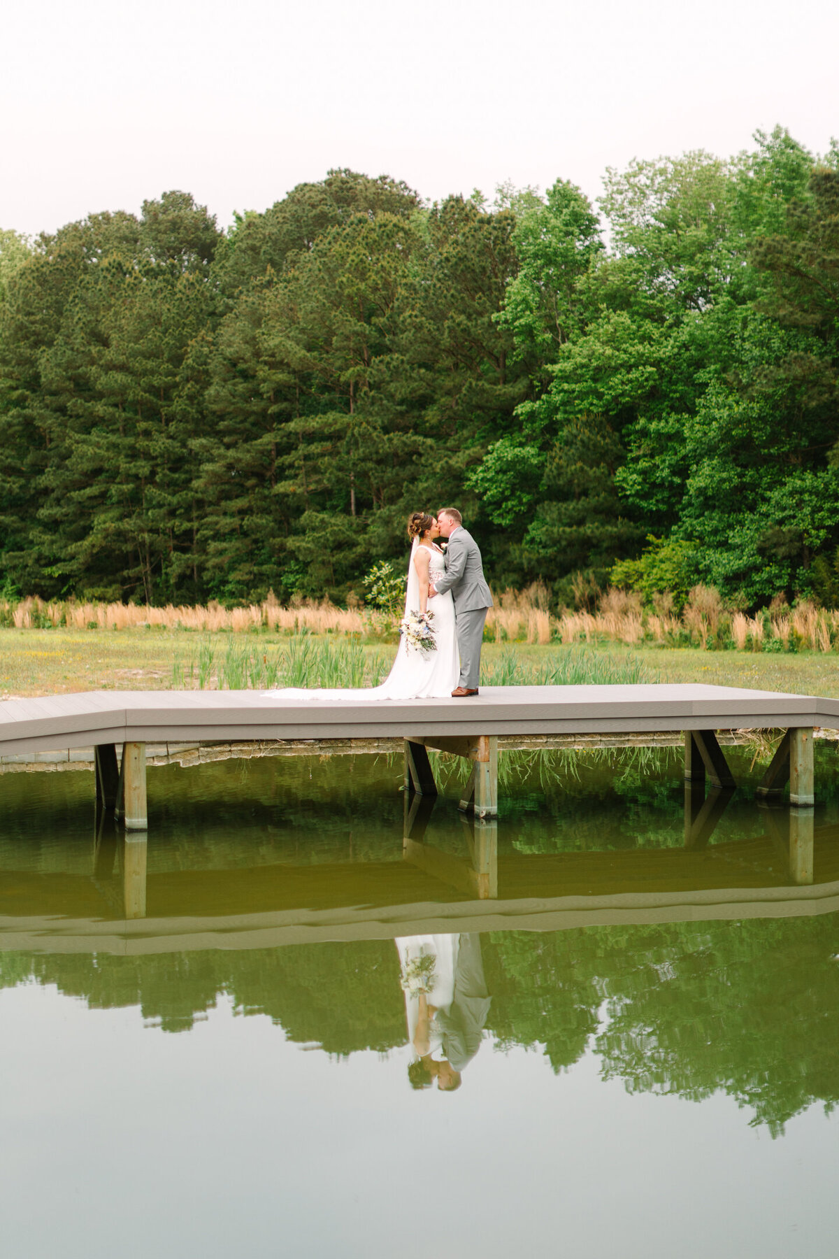 New Branch Farms Wedding reflection photo of bride and groom on the bridge over the water