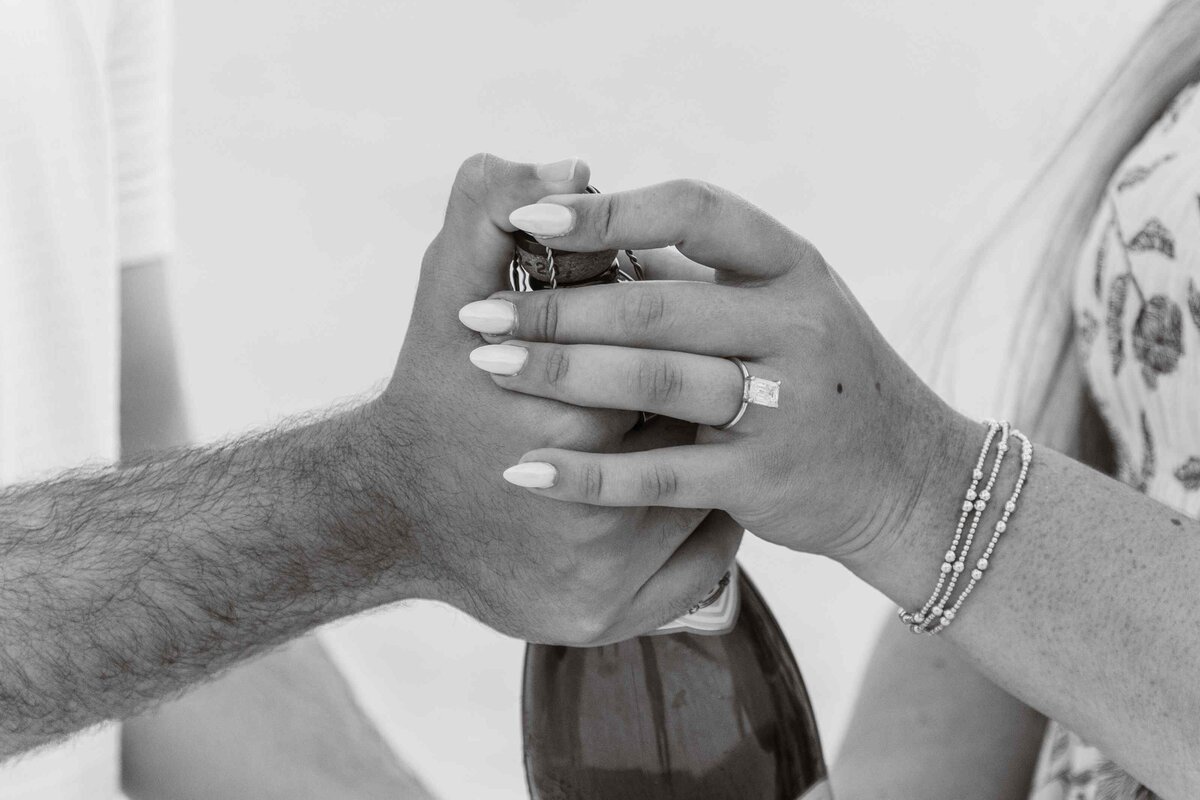 11-montone-couples-hands-champagne-bottle