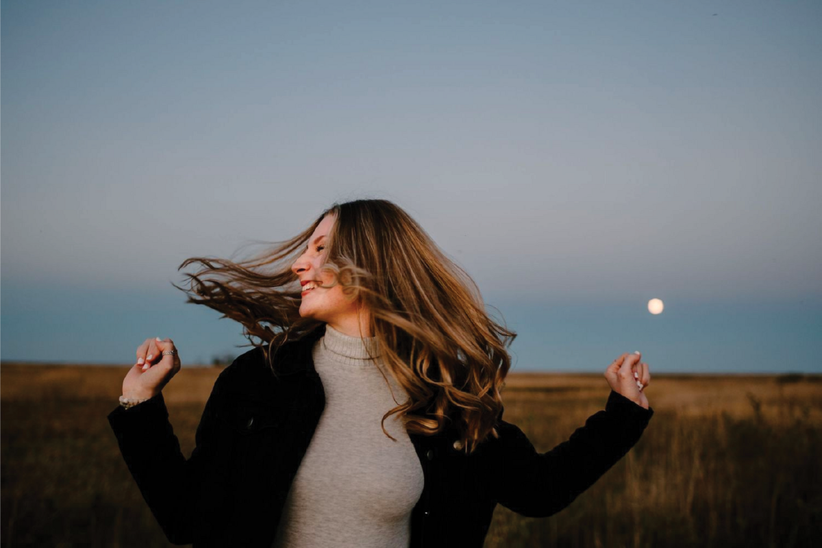 girl-smiling-with-moon-in-bg