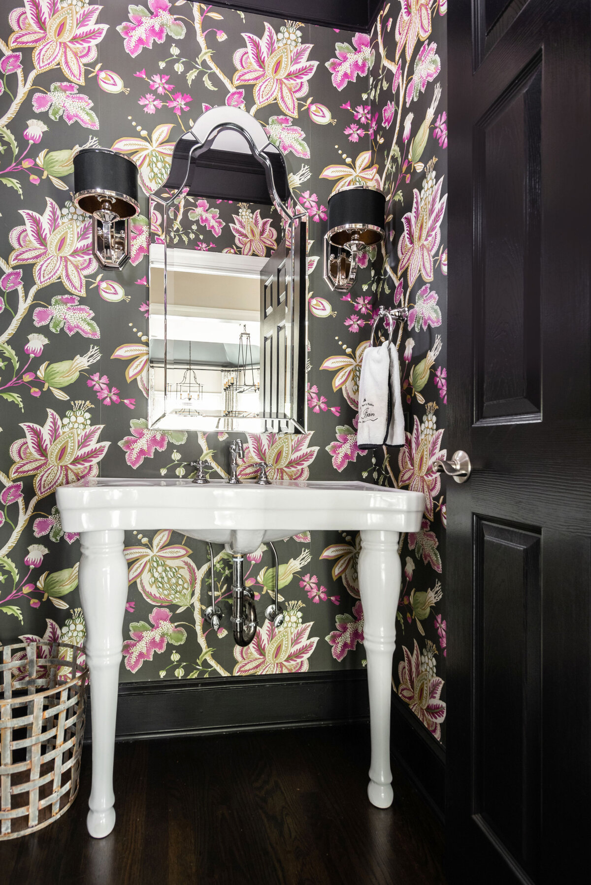 Glamorous bathroom in Lake Norman, NC, featuring floral wallpaper and a vintage-inspired vanity.