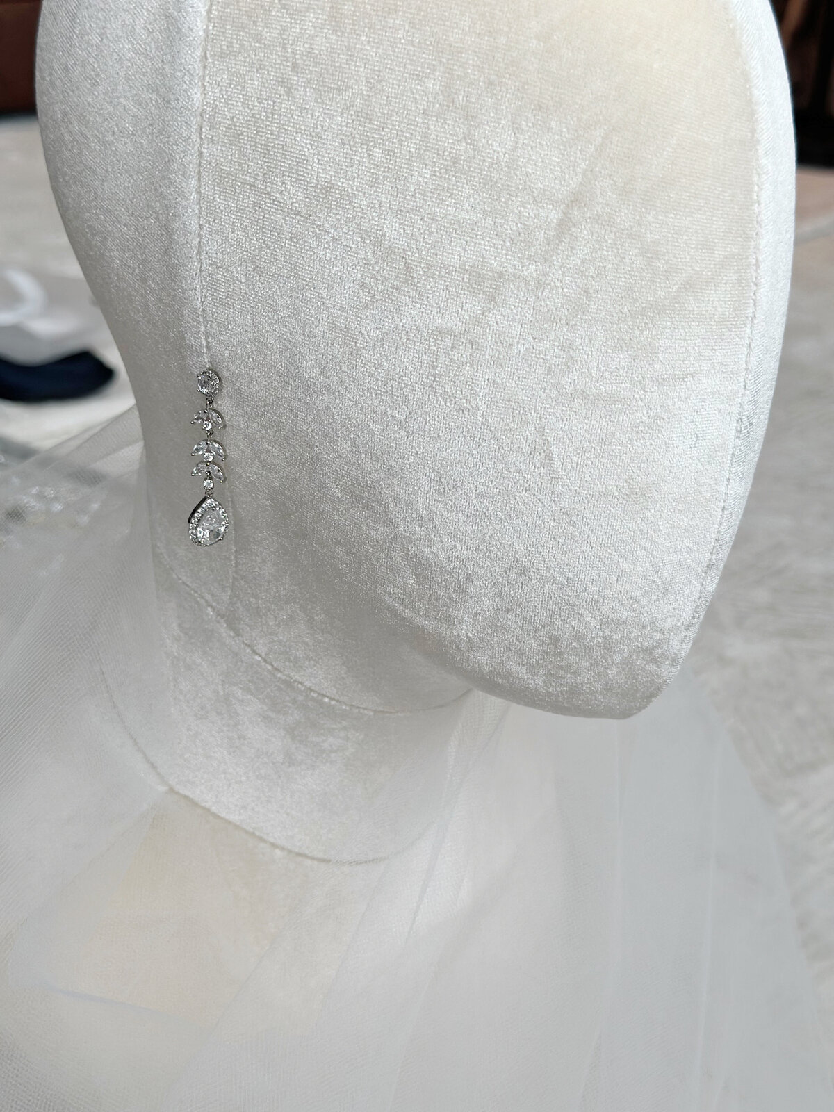 Bride wearing classic crystal drop earrings with pearl accents
