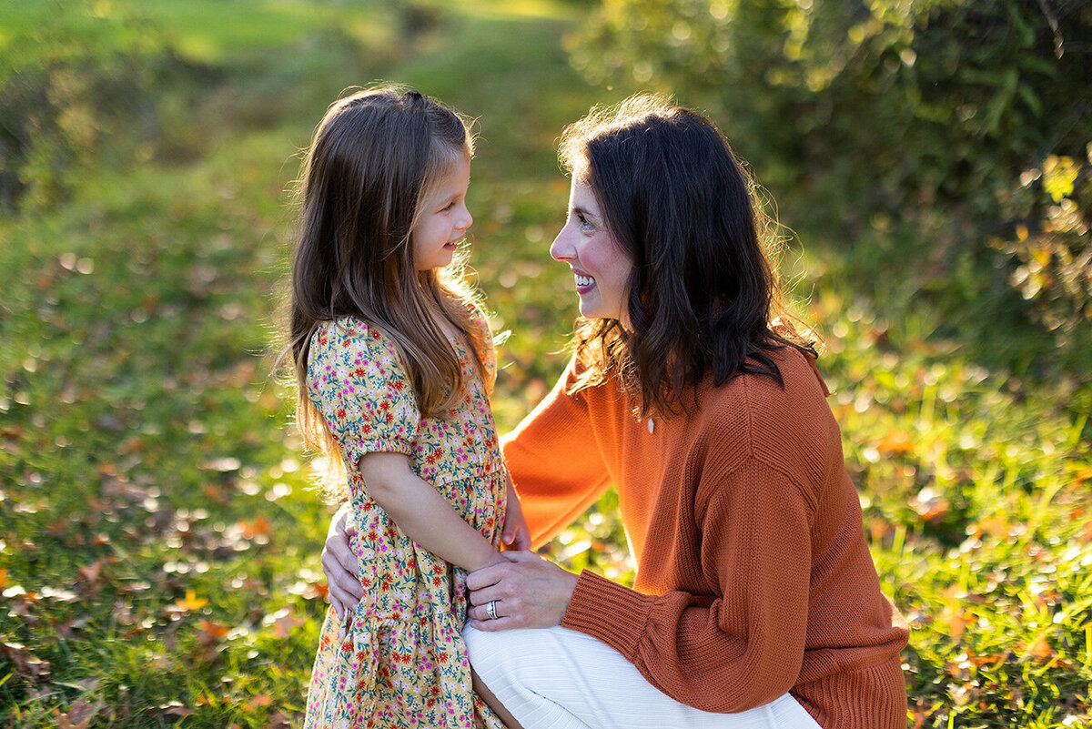 Mother holds daughters face in picture  for Irwin family