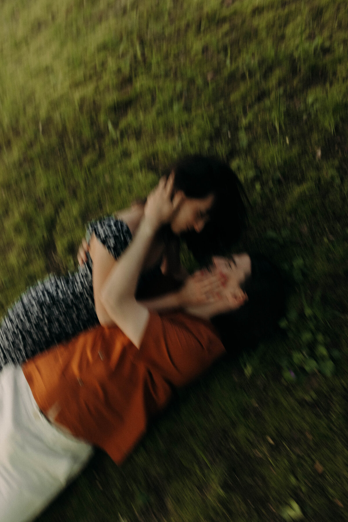 editorial engagement photography rolling in the grass