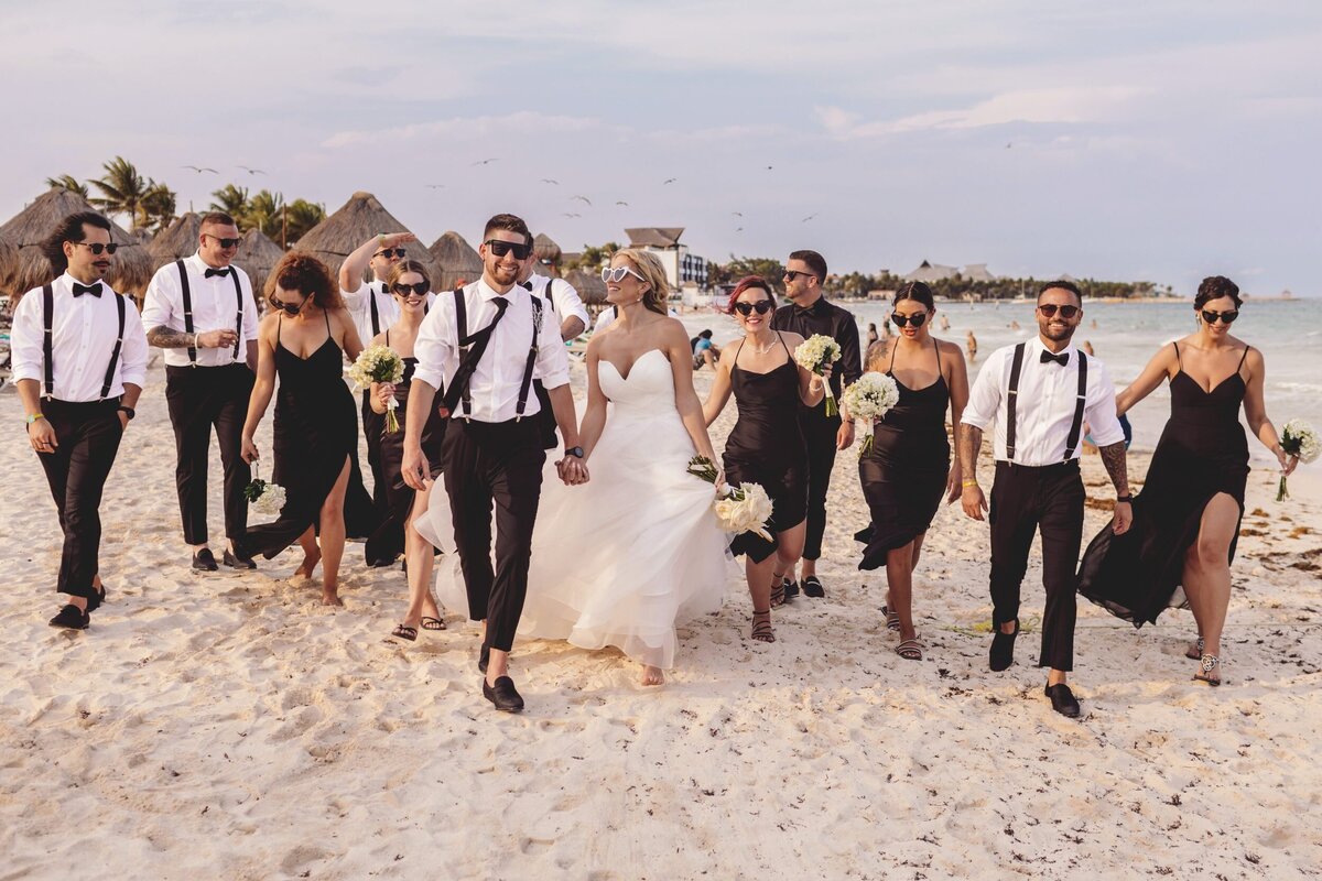 Bridal party walking and laughing on beach at  Iberostar Paraiso Riviera Maya Wedding